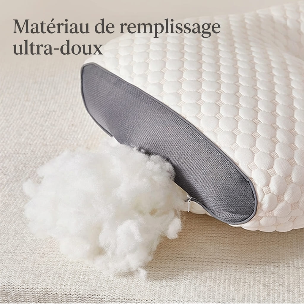 Gros plan sur le matériau de remplissage ultra-doux en fibres blanches sortant d'un oreiller cervical bicolore pour illustrer le moelleux et la qualité du rembourrage.